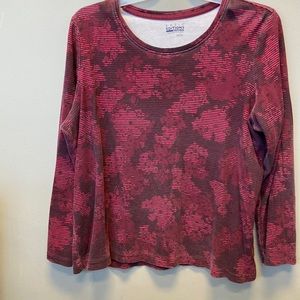 Woman’s long sleeved maroon floral blouse.